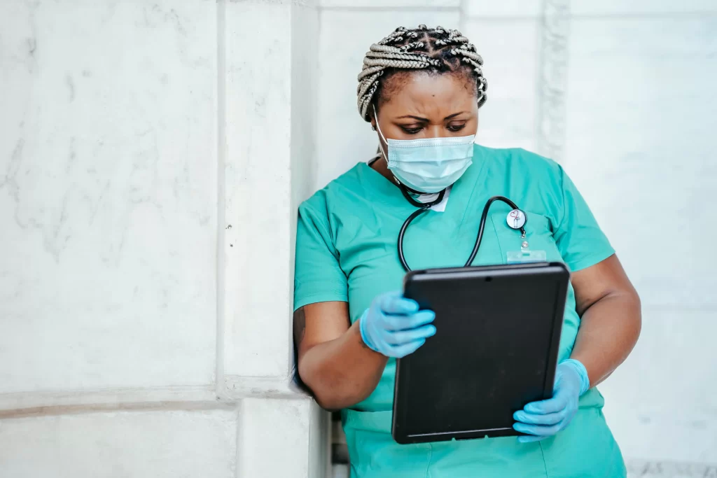 A health professional looking at a medical document.