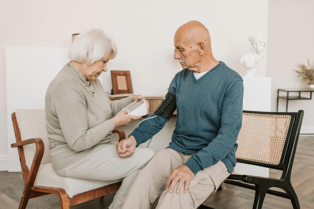 Married couple taking each others blood pressure