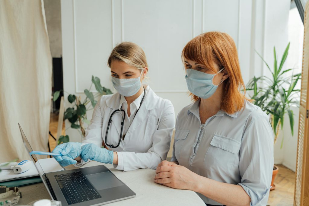 Doctor showing a patient something on the computer